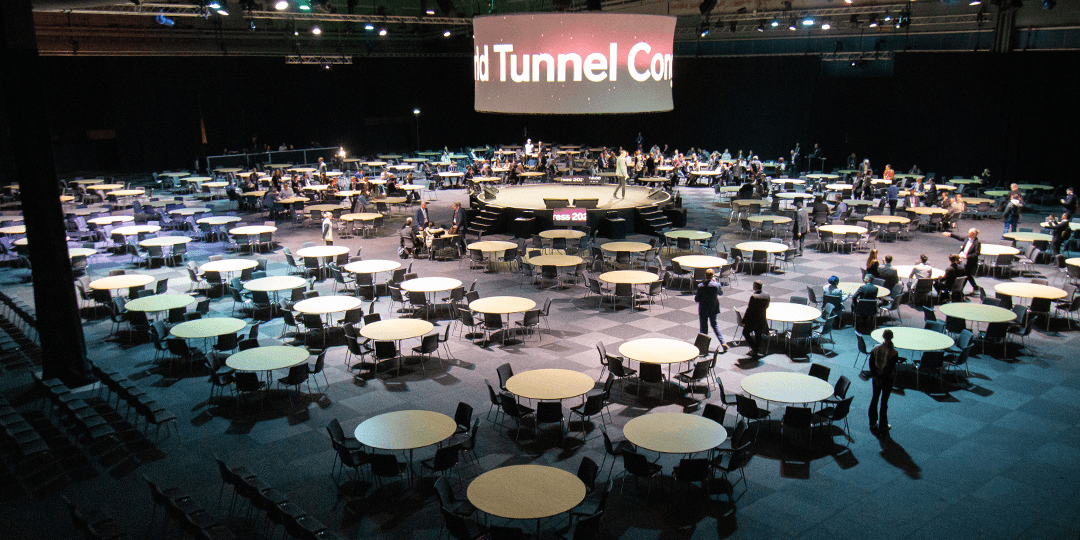 Large round tables surround a central stage, the Think Tank, in one of Stockholmsmässan's halls during an ongoing congress.