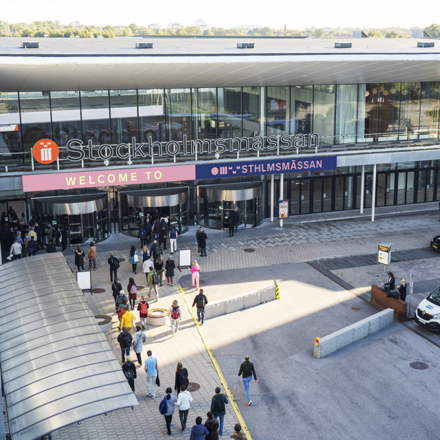 The main entrance to Stockholmsmässan during an event with people moving towards the entrance.