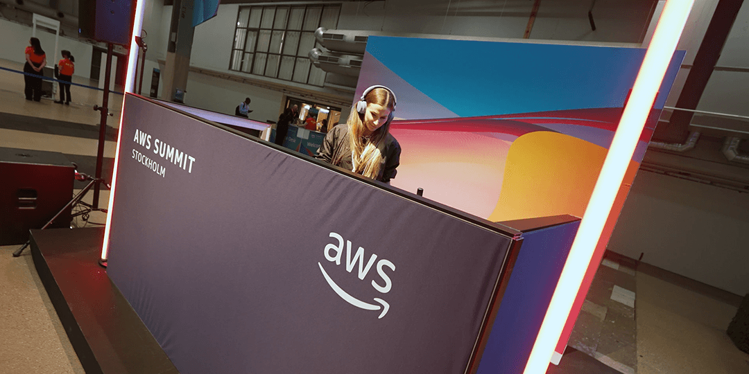 DJ playing music in the entrance area during AWS Summit Stockholm.
